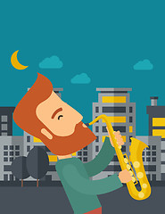 Image showing Saxophonist playing in the streets at night