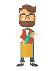 Image showing Wine maker holding a bottle of wine.