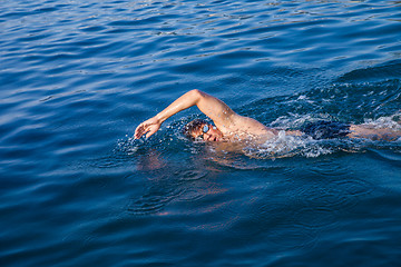 Image showing Man swimming in blue water