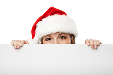 Image showing Christmas woman in santa hat holding empty board