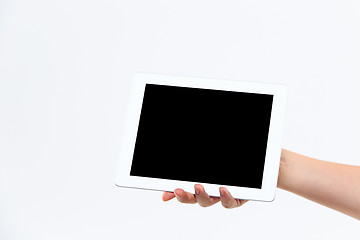 Image showing Human hand holding tablet