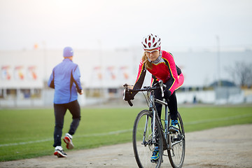 Image showing Sport girl cycling in the autumn overcast weather day