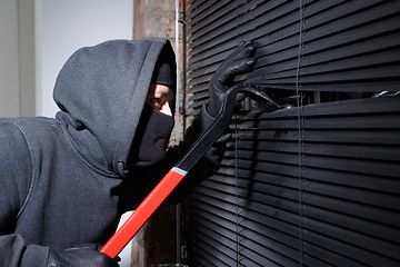 Image showing Thief trying to open window