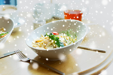 Image showing close up of pasta in bowl on table at restaurant