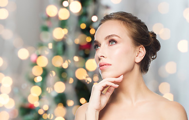 Image showing beautiful woman face over christmas lights