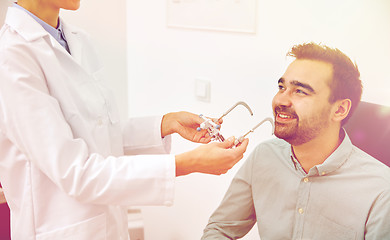 Image showing optician with trial frame and patient at clinic