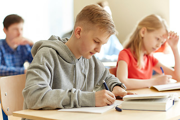 Image showing group of students with books writing school test