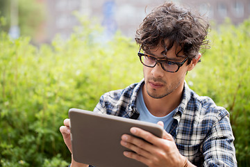 Image showing man in glasses with tablet pc computer outdoors