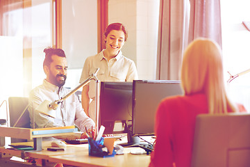 Image showing happy creative team with computers in office