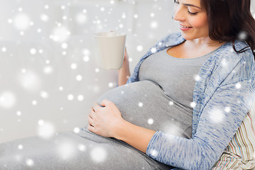 Image showing close up of pregnant woman drinking tea at home