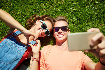 Image showing happy couple taking selfie on smartphone at summer