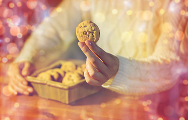 Image showing close up of woman with christmas  oat cookies