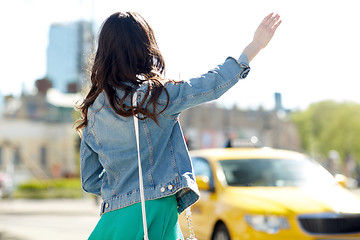 Image showing young woman or girl catching taxi on city street