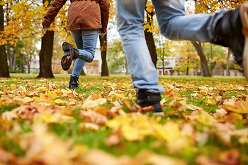 Image showing young couple running in autumn park