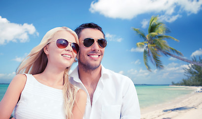 Image showing couple in shades over tropical beach background