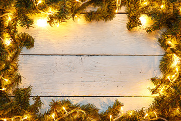 Image showing Christmas template greeting card with shining garland and tree branches