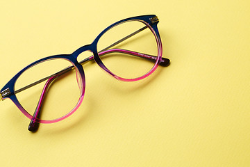 Image showing Blue-pink glasses on yellow background