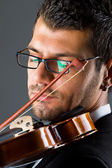 Image showing Musician with violin on dark background