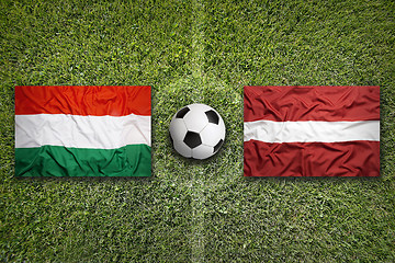 Image showing Hungary vs. Latvia flags on soccer field