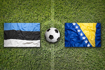 Image showing Estonia vs. Bosnia and Herzegovina flags on soccer field