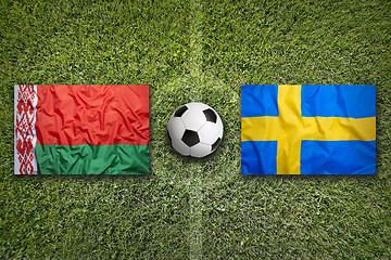 Image showing Belarus vs. Sweden flags on soccer field