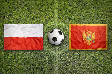 Image showing Poland vs. Montenegro flags on soccer field