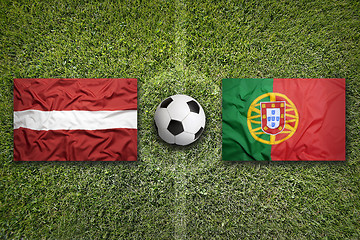 Image showing Latvia vs. Portugal flags on soccer field