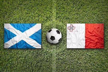 Image showing Scotland vs. Malta flags on soccer field