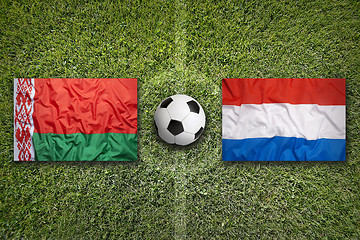 Image showing Belarus vs. Netherlands flags on soccer field