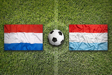 Image showing Netherlands vs. Luxembourg flags on soccer field