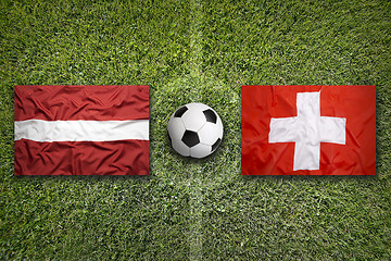 Image showing Latvia vs. Switzerland flags on soccer field