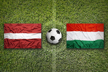 Image showing Latvia vs. Hungary flags on soccer field