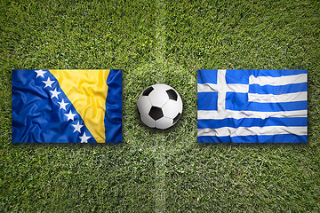 Image showing Bosnia and Herzegovina vs. Greece flags on soccer field