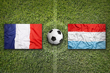 Image showing France vs. Luxembourg flags on soccer field