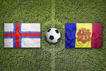 Image showing Faroe Islands vs. Andorra flags on soccer field