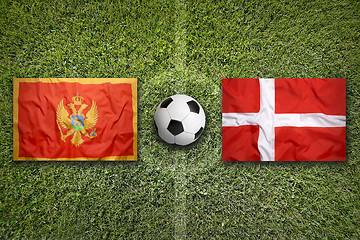 Image showing Montenegro vs. Denmark flags on soccer field