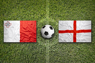 Image showing Malta vs. England flags on soccer field