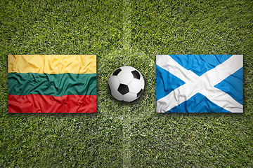 Image showing Lithuania vs. Scotland flags on soccer field