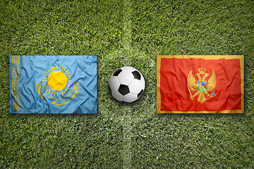 Image showing Kazakhstan vs. Montenegro flags on soccer field