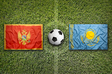 Image showing Montenegro vs. Kazakhstan flags on soccer field