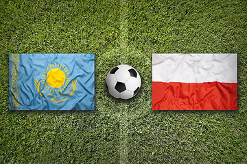 Image showing Kazakhstan vs. Poland flags on soccer field