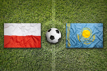 Image showing Poland vs. Kazakhstan flags on soccer field