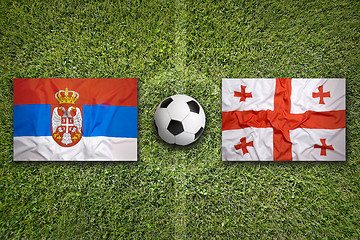 Image showing Serbia vs. Georgia flags on soccer field