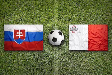 Image showing Slovakia vs. Malta flags on soccer field