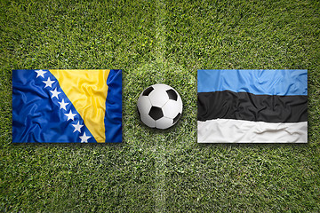 Image showing Bosnia and Herzegovina vs. Estonia flags on soccer field