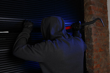 Image showing Night burglar trying open door