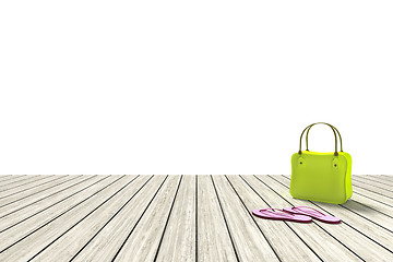 Image showing green bag on a wooden floor with white background