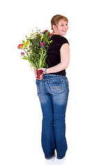 Image showing Happy smiling young girl presenting flowers