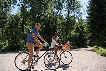 Image showing Young multiethnic couple having a bike ride in nature