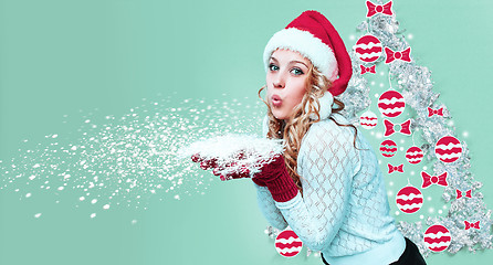 Image showing Beautiful young woman in Santa Claus clothes with snowflakes